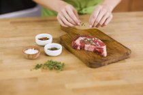 Woman Seasoning Steak — Stock Photo