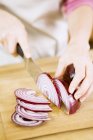 Woman Slicing Red Onion on Cutting Board — Stock Photo