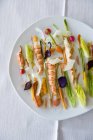Gambas with vegetables on white plate — Stock Photo