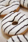 Iced donuts with chocolate stripes — Stock Photo