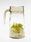 Glass carafe with lemons and ice cubes — Stock Photo