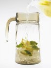 Filling carafe with essence of lemonade — Stock Photo