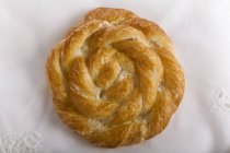 Closeup top view of round braided pastry on white surface — Stock Photo