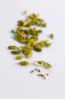 Opened and whole Cardamom pods — Stock Photo