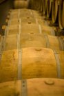 Elevated view of wooden barrels rows in wine cellar — Stock Photo