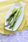 Green asparagus with orange zest — Stock Photo