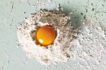 Egg yolk on flour — Stock Photo