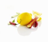 Lemon and chili peppers — Stock Photo