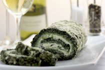 Spinach roulade with water cress on white plate — Stock Photo
