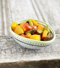 Small Bowl of Roasted Vegetables over wooden surface — Stock Photo