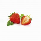 Whole strawberry and half strawberry — Stock Photo
