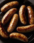 Meat sausages frying — Stock Photo