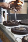 Chocolate cake being glazed — Stock Photo