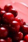 Cranberries in glass jug — Stock Photo