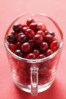 Cranberries in measuring jug — Stock Photo