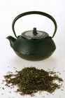 Tea in front of teapot — Stock Photo