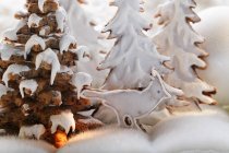 Closeup view of winter forest scene with gingerbread trees and bird — Stock Photo