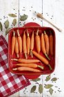 Carrots in red baking dish — Stock Photo
