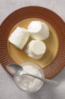 Three Petit Suisse cheese pieces with salt and spoon — Stock Photo