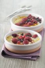 Closeup view of two berry gratins in bowls on towel — Stock Photo