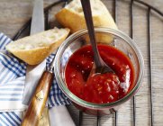Homemade barbecue sauce in a jar with a spoon — Stock Photo