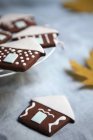 Closeup view of chocolate houses with white fondant roofs — Stock Photo