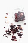 Elevated view of dried Hibiscus flowers in a jar and on a white cloth — Stock Photo