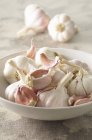 Garlic in white bowl — Stock Photo