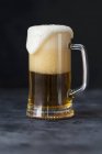 Glass of beer with foam — Stock Photo