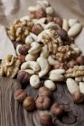 Closeup view of assorted nuts on wooden surface — Stock Photo