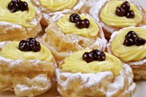 Closeup view of Zeppole di San Giuseppe choux pastries with cream and cherries — Stock Photo