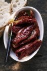 Marinated dried tomatoes with white bread — Stock Photo