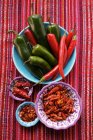 Fresh and dried chili peppers — Stock Photo