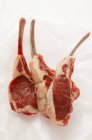 Fresh lamb cutlets on paper — Stock Photo