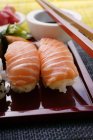 Nigiri sushi on red platter — Stock Photo