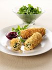 Closeup view of turkey Croquettes with rocket salad and cranberry sauce — Stock Photo