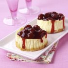 Mini cheesecakes with cherry sauce — Stock Photo