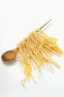 Homemade pasta hanging on spoon — Stock Photo