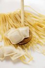 Homemade ribbon pasta and ravioli — Stock Photo