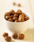 Hazelnut kernels in white bowl — Stock Photo