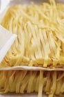 Ribbon pasta on paper — Stock Photo
