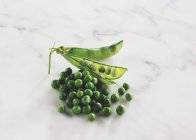 Ervilhas verdes frescas com vagem — Fotografia de Stock