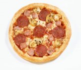 Pizza with salami, ham and mushrooms — Stock Photo