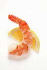 Cooked peeled shrimp on wedge of lemon — Stock Photo