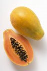 Whole and half papaya — Stock Photo
