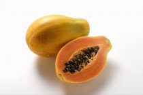 Whole and half papaya — Stock Photo