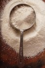Top view of white cornmeal heap with measuring jug — Stock Photo