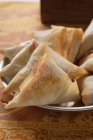 Closeup view of filled pastry triangles on plate — Stock Photo