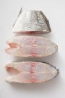 Sea bass cutlets and piece of tail — Stock Photo