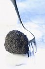 Black truffle with fork — Stock Photo